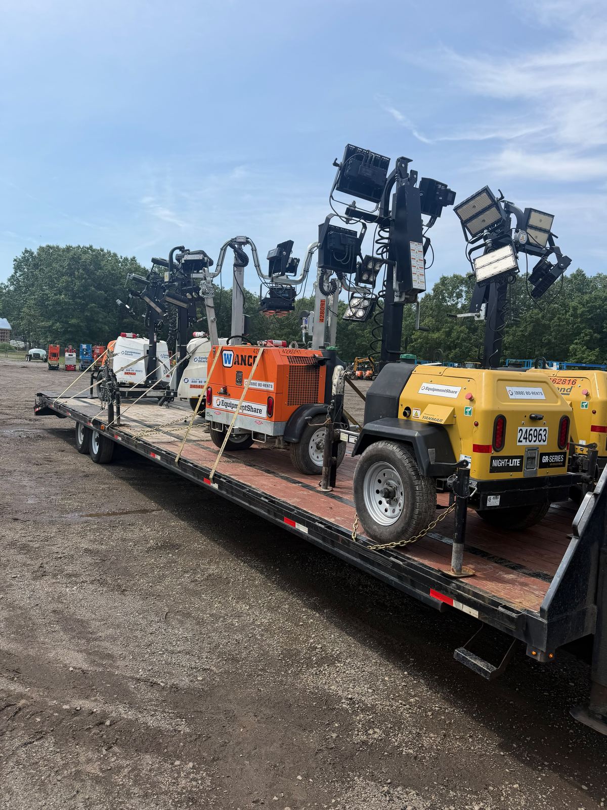 Portable light towers chained down on a flatbed trailer